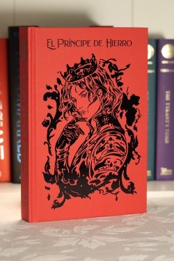 A red hardcover book with the words 'El Principe de Hierro', with a large image of a prince underneath.